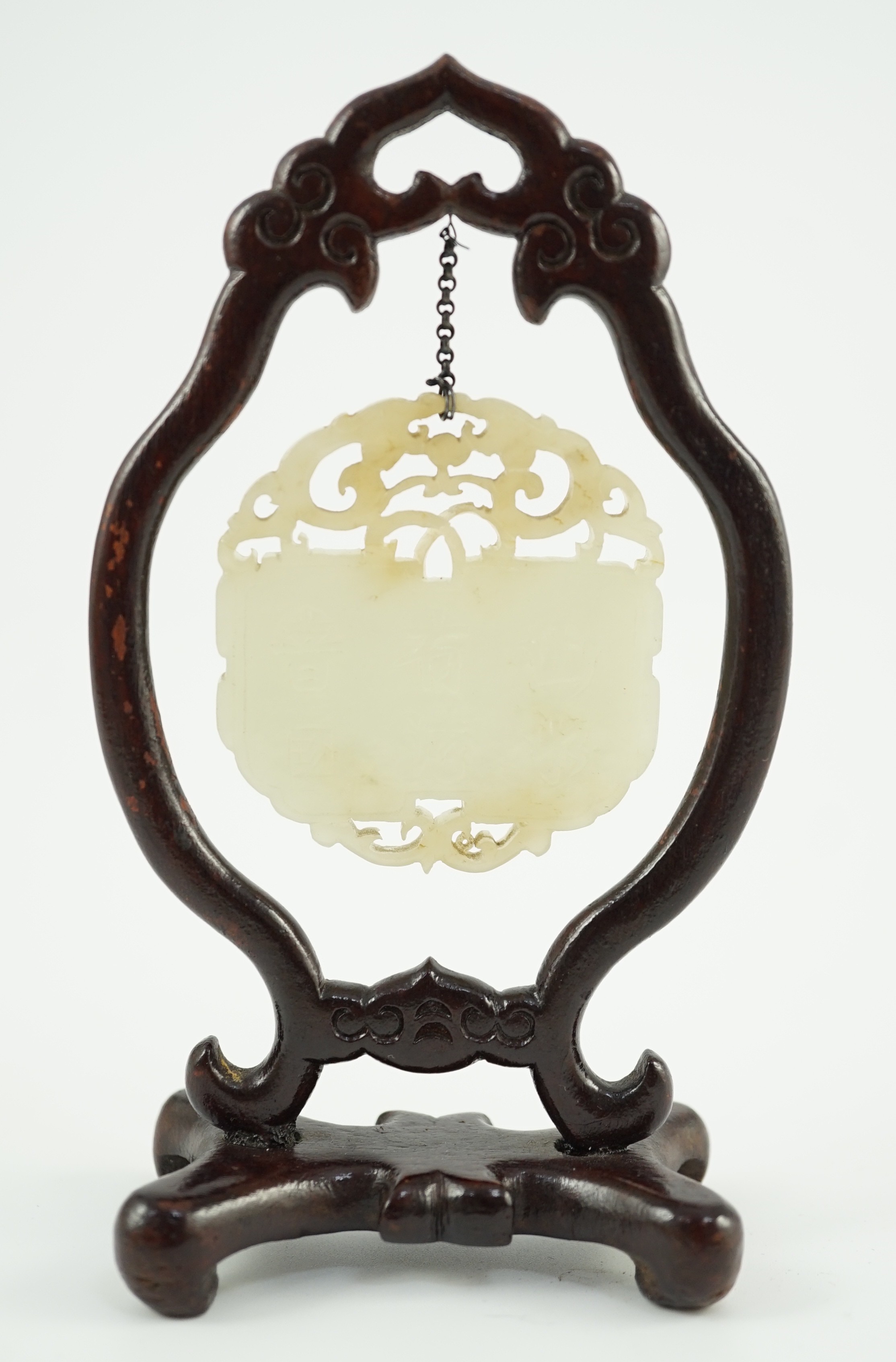 A Chinese pale celadon jade inscribed plaque, 19th/20th century, 5.1cm, suspended from a wood stand